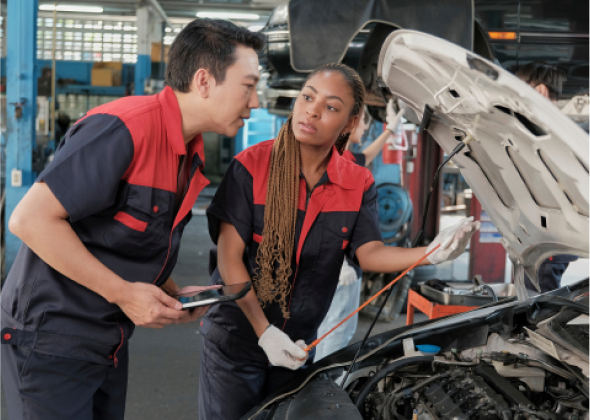 Mechanics inspect the engine of a car